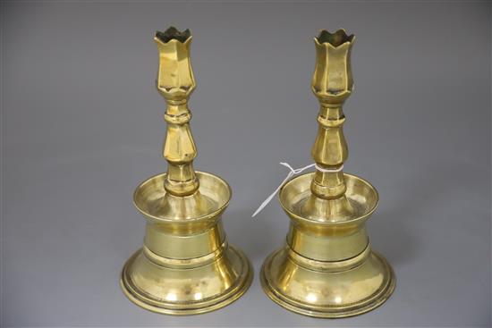 A pair of 17th century Ottoman brass bell based candlesticks, H.9in.
